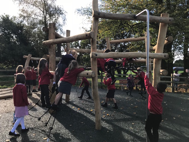 school children on a climbing frame
