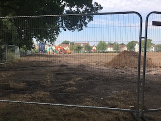 a building site behind a fence